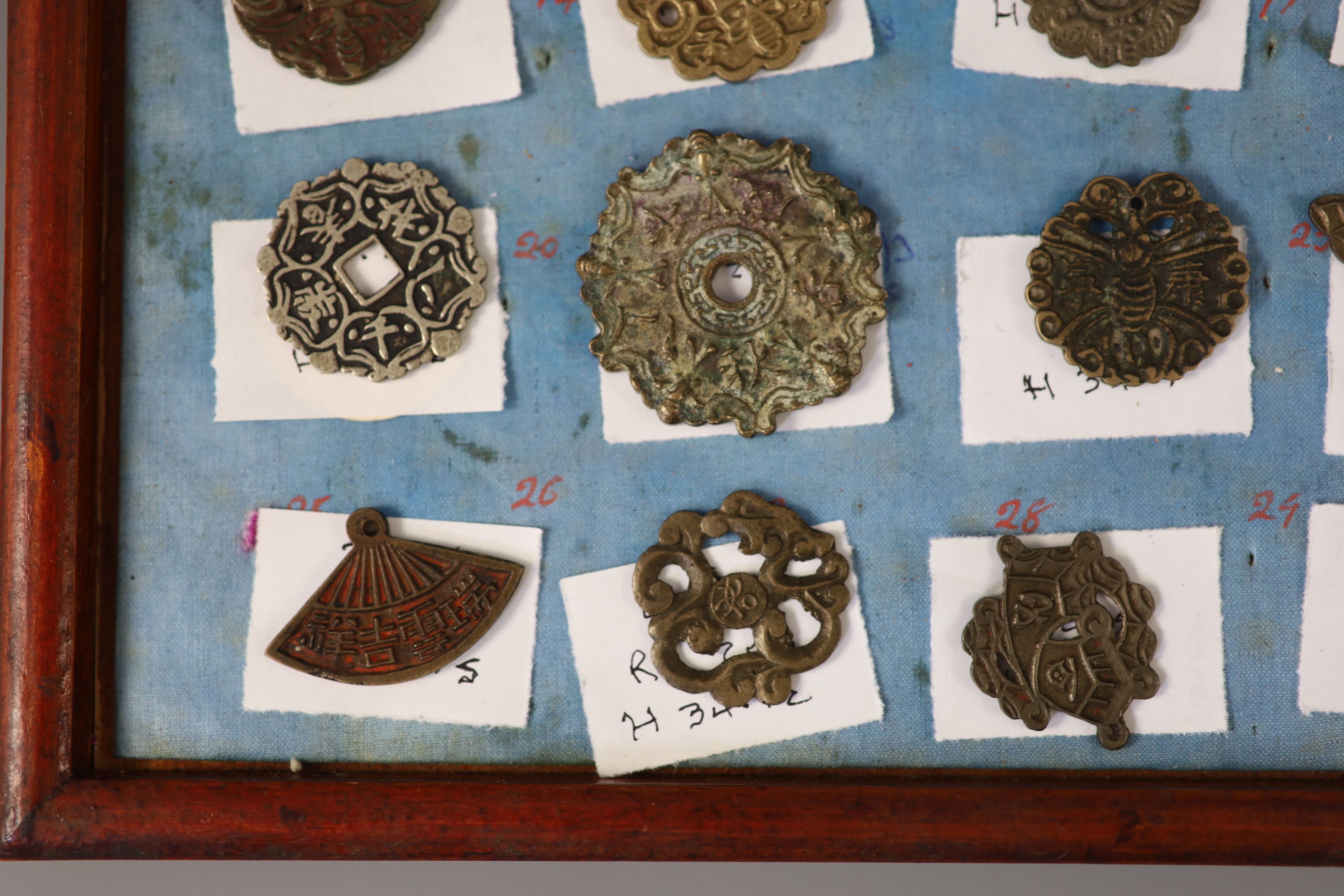 A group of 99 Korean bronze and metal amulets or charms, 19th/20th century